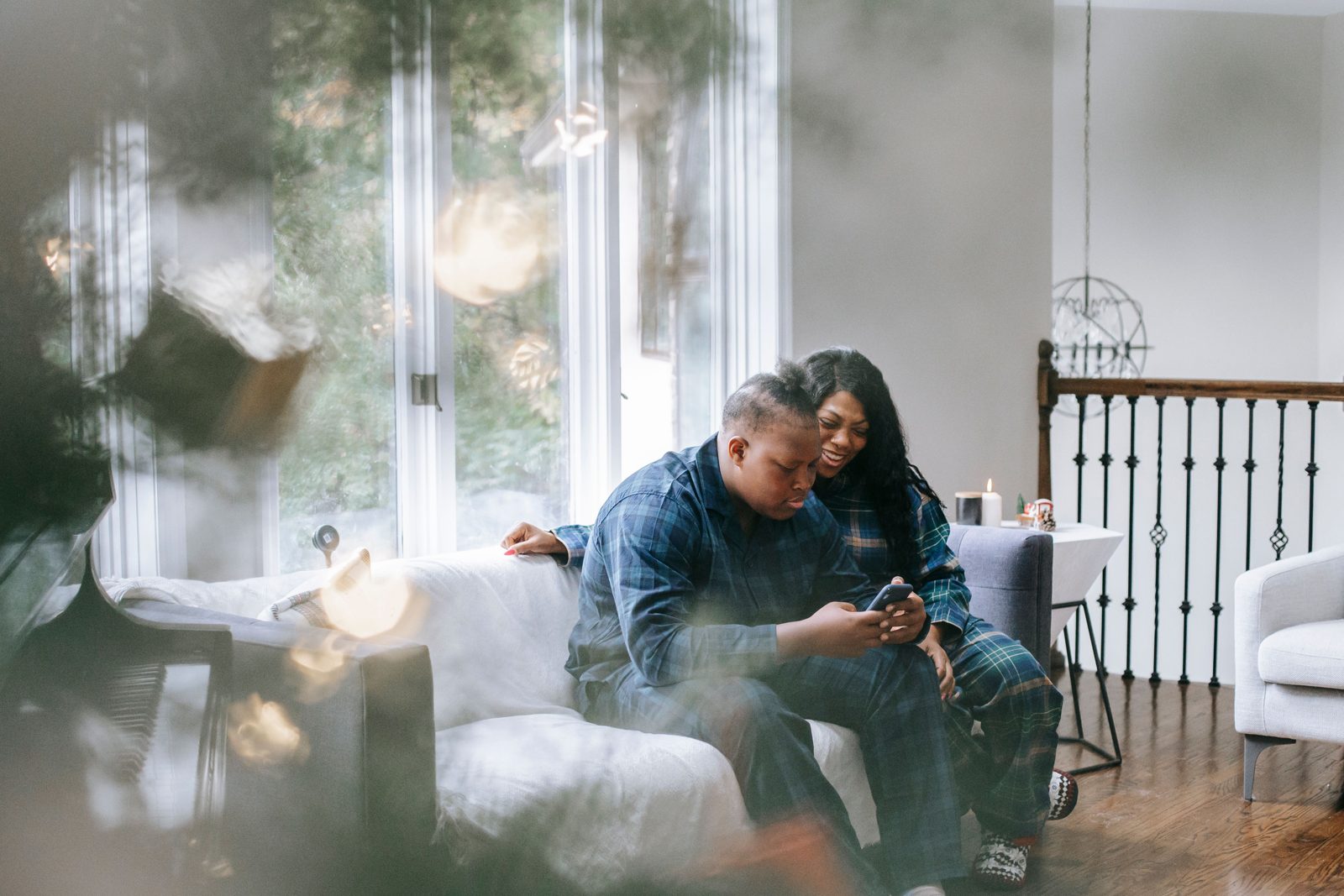 Parent and teenager with smartphone at home